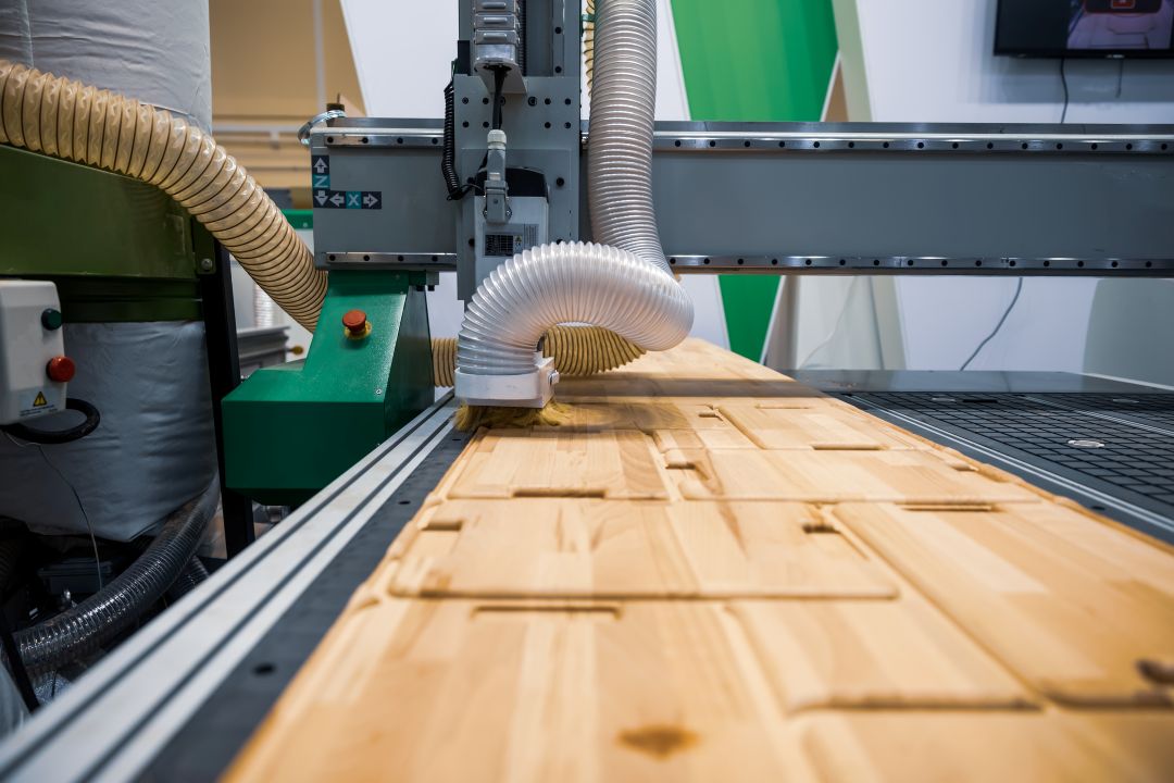 CNC machine cutting wood for custom woodworking projects at VHC Wood Products.