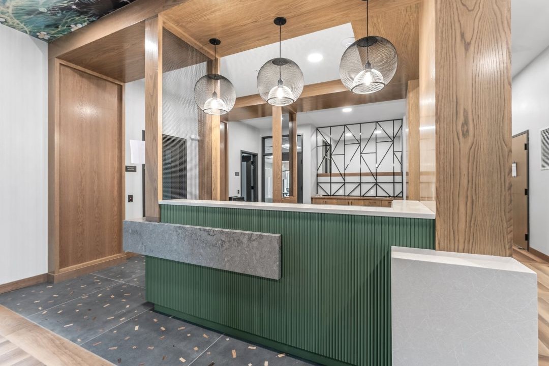 Custom reception desk with modern wood design crafted by VHC Wood Products.